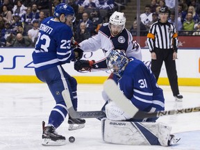 Maple Leafs goaltender Frederik Andersen makes a save in front of Columbus Blue Jackets' Oliver Bjorkstrand as Toronto defenceman Travis Dermott closes in during third period action in Toronto on Wednesday night.