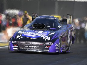 In this photo by NHRA, Jack Beckman makes a run in Funny Car qualifying for the Lucas Oil NHRA Winternationals at Auto Club Raceway on Friday, Feb. 9, 2018, in Pomona, Calif.