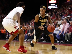 Purdue forward Vincent Edwards (12) drives to the basket past Rutgers guard Corey Sanders during the first half of an NCAA college basketball game Saturday, Feb. 3, 2018, in Piscataway, N.J.