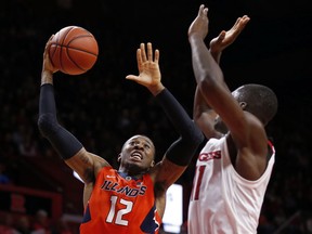 Illinois forward Leron Black (12) drives to the basket past Rutgers forward Eugene Omoruyi (11) during the first half of an NCAA college basketball game Sunday, Feb. 25, 2018, in Piscataway, N.J.