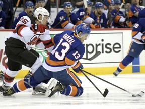 New Jersey Devils defenseman Sami Vatanen (45) and New York Islanders center Mathew Barzal (13) vie for the puck during the first period of an NHL hockey game Saturday, Feb. 24, 2018, in Newark, N.J.