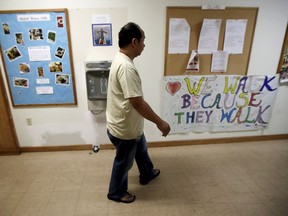 In this Oct. 12, 2017 photo, Arthur Jemmy walks through a hallway at The Reformed Church of Highland Park, where he and his wife are taking sanctuary to avoid deportation in Highland Park, N.J. The church, who is led by pastor Seth Kaper-Dale, who has a history of hosting immigrants in danger of deportation. A federal judge on Friday, Feb. 2, 2018, has temporarily halted deportation proceedings against Indonesian Christians who are in the U.S. illegally but are seeking to gain legal status.