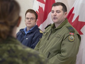 Maj. Mark Norris of the Joint Rescue Coordination Centre, right, and Canadian Coast Guard officer Marc Ouellette announce that they are scaling back their search for the captain of a fishing vessel that ran aground off Canso, N.S., in Halifax on Thursday, Feb. 8, 2018.