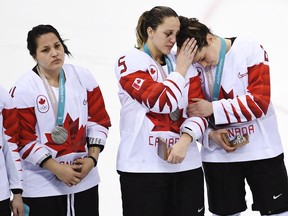 Canada defenceman Lauriane Rougeau (5) comforts forward Rebecca Johnston (6) after losing to the United States in shootout women's gold medal final Olympic hockey action at the 2018 Olympic Winter Games in Gangneung, South Korea on Thursday, February 22, 2018. Canada's drive for a fifth straight gold medal in women's hockey ended early today when the U.S. won 3-2 in a shootout.