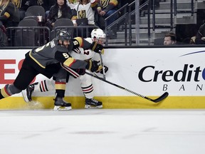 Vegas Golden Knights defenseman Deryk Engelland (5) and Chicago Blackhawks left wing Lance Bouma chase down the puck during the first period of an NHL hockey game Tuesday, Feb. 13, 2018, in Las Vegas.