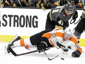 Vegas Golden Knights right wing Pierre-Edouard Bellemare (41) reaches under Philadelphia Flyers center Jori Lehtera (15) during the first period of and NHL hockey game Sunday, Feb. 11, 2018, in Las Vegas.