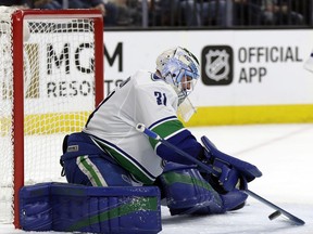 Vancouver Canucks goalie Anders Nilsson stops a shot during the first period of the team's NHL hockey game against the Vegas Golden Knights on Friday, Feb. 23, 2018, in Las Vegas.