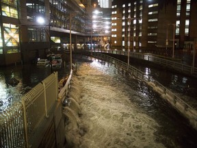 FILE - In this Oct. 29, 2012, file photo, seawater floods the entrance to the Brooklyn Battery Tunnel in New York in the wake of Superstorm Sandy. New satellite research shows that global warming is making seas rise at an ever increasing rate. Scientists say melting ice sheets in Greenland and Antarctica is speeding up sea level rise so that by the year 2100 on average oceans will be two feet higher than today, probably even more.