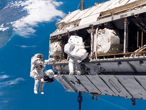 FILE - In this Dec. 12, 2006, file photo, made available by NASA, astronaut Robert L. Curbeam Jr., left, and European Space Agency astronaut Christer Fuglesang, participate in a space walk during construction of the International Space Station. Under President Donald Trump's 2019 proposed budget released, Monday, Feb. 12, 2018, U.S. government funding for the space station would cease by 2025. The government would set aside $150 million to encourage commercial development. (NASA via AP, File)