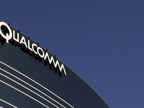 FILE - In this Nov. 2, 2011, file photo, a sign sits atop the Qualcomm headquarters building in San Diego.  Qualcomm is raising its takeover bid for NXP Semiconductors by nearly 16 percent to about $43.22 billion, citing in part NXP's strong results since the companies first announced their merger in October 2016. The move announced Tuesday, Feb. 20, 208,  comes as Qualcomm itself is in the crosshairs of Broadcom Ltd., which earlier this month raised its own cash and stock bid for Qualcomm to $121 billion.