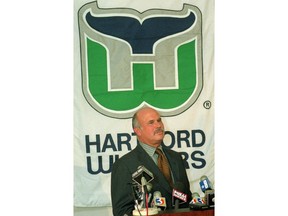 FILE - In this May 15, 1996, file photo, Peter Karmanos, owner of the NHL hockey team Hartford Whalers, answers a question during a news conference in Hartford, Conn. The new owner of the Carolina Hurricanes has a soft spot for his team's old identity _ the Hartford Whalers. In the month since Tom Dundon assumed control of the Carolina Hurricanes, from Karmanos, they've brought back "Brass Bonanza," stocked the shelves in the team store with that beloved whale-tail logo and have discussed bringing back the Whalers, too _ if only for a future turn-back-the-clock night.