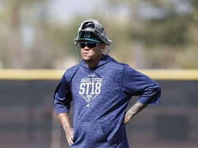 FILE - In this Feb. 19, 2018, file photo, Seattle Mariners starting pitcher Felix Hernandez watches a drill during a baseball spring training workout, in Peoria, Ariz. So far the story of spring training for the Mariners is the growing list of injuries. The latest is Felix Hernandez who took a liner off his right arm and now may see his Catcus League plans altered.