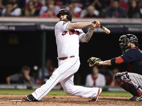 FILE - In this Oct. 6, 2016, file photo, Cleveland Indians' Mike Napoli bats against the Boston Red Sox during Game 1 of baseball's American League Division Series,in Cleveland. Napoli is getting another swing with the Indians. The free agent slugger has agreed to a minor league contract with the team, pending the completion of a physical. Napoli spent 2016 with the Indians and had a major role in getting the club to the World Series.