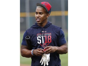 FILE - In this Feb. 16, 2018, file photo, Cleveland Indians shortstop Francisco Lindor smiles as he finishes up with batting practice at the Indians spring training facility, in Goodyear, Ariz. Even months after Cleveland's unexpected loss to the New York Yankees in the AL playoffs, the Indians' All-Star shortstop hasn't shaken the sting of a special season ending well short of a World Series title.