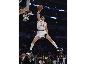 FILE - In this Feb. 17, 2018, file photo, Cleveland Cavaliers' Larry Nance Jr. competes in the slam dunk contest, part of the NBA basketball All-Star weekend in Los Angeles. Nance has run into an unexpected snag since joining the Cavaliers. "Trying to convince my mom that I'm not living at home," he said, smiling. "We're out looking for rental properties and stuff like that and she's like, 'Oh, our basement is pretty nice.' That's probably been the toughest thing." Nance wore his dad's Phoenix jersey and replicated the same dunk Larry Nance Sr. did while winning the inaugural dunk contest in 1984.