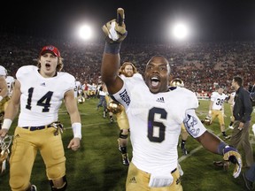 FILE - In this Nov. 24, 2012, file photo, Notre Dame running back Theo Riddick, right, and wide receiver Luke Massa, left, celebrate after Notre Dame defeated Southern California 22-13 in an NCAA college football game in Los Angeles. The NCAA has denied Notre Dame's appeal of a decision to vacate 21 victories because of academic misconduct, including all 12 wins from the school's 2012 national championship game run.