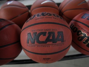 FILE - In this March 22, 2010, file photo, basketballs are seen before Northern Iowa's NCAA college basketball practice, in Cedar Falls, Iowa. Bank records and other expense reports that are part of a federal probe into college basketball list a wide range of impermissible payments from agents to at least two dozen players or their relatives, according to documents obtained by Yahoo Sports. NCAA president Mark Emmert said in a statement Friday, Feb. 23, 2018, the allegations "if true, point to systematic failures that must be fixed and fixed now if we want college sports in America."