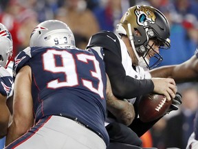 FILE - In this Jan. 21, 2018, file photo, Jacksonville Jaguars quarterback Blake Bortles (5) is sacked by New England Patriots defensive end Lawrence Guy (93) during the second half of the AFC championship NFL football game in Foxborough, Mass. The Patriots have always had a knack for getting production out of late-round draft picks and undrafted free agents. This season in no exception with previously unknown players like 2011 seventh-round draft pick Lawrence Guy and Ricky Jean Francois, a seventh-round pick in 2009, both making key contributions on the defensive line.