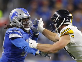 FILE - In this Oct. 29, 2017, file photo, Pittsburgh Steelers tight end Jesse James (81) blocks Detroit Lions defensive end Ezekiel Ansah (94) during an NFL football game in Detroit. The Lions have designated Ansah as their franchise player. The Lions announced the decision Tuesday, Feb. 27, 2018. Ansah, a first-round draft pick in 2013, has 44 sacks in five years with Detroit, including 12 this past season.