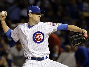FILE - In this Oct. 17, 2017, file photo, Chicago Cubs starting pitcher Kyle Hendricks throws during the first inning of Game 3 of baseball's National League Championship Series against the Los Angeles Dodgers, in Chicago. Coming off an historic World Series title, the Cubs got off to a slow start last year and had to push themselves in the second half to overcome Milwaukee and win the NL Central. "I think it just teaches you how every year is so different," Hendricks said, "not just the season, but the offseason too, and how you get your body ready.