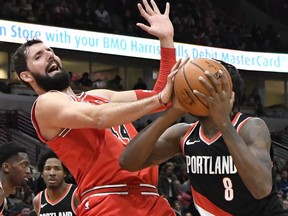 FILE- In this Jan. 1, 2018, file photo, Chicago Bulls forward Nikola Mirotic, left, defends against Portland Trail Blazers forward Al-Farouq Aminu (8) during the second half of an NBA basketball game in Chicago. A person familiar with the decision says the New Orleans Pelicans have acquired forward Nikola Mirotic and a second-round draft pick from the Chicago Bulls for center Omer Asik, guards Jameer Nelson and Tony Allen, and a future first-round pick. The person spoke to The Associated Press on condition of anonymity Thursday, Feb. 1, 2018,  because neither team has announced the trade.
