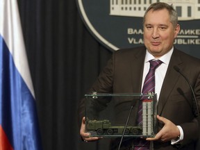 FILE - In this Monday, Jan. 11, 2016 file photo, Russian Deputy Prime Minister Dmitry Rogozin holds a model of an S-300 surface-to-air missile system at a news conference in Belgrade, Serbia. In May 2015, Rogozin invoked the X-37B unmanned space plane as evidence that his country's space program was faltering. "The United States is pushing ahead," he warned Russian lawmakers. Less than two weeks later, the hacking group Fancy Bear tried to penetrate the Gmail account of a senior engineer on the X-37B project at Boeing.