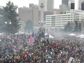FILE - In this April 20, 2013 file photo, members of a crowd numbering tens of thousands smoke marijuana at the Denver 4/20 pro-marijuana rally at Civic Center Park in Denver. According to a report released on Monday, Feb. 12, 2018, the day marijuana users celebrate as their own holiday is linked with a slight increase in fatal U.S. car crashes, in an analysis of 25 years of data. Whether pot was involved in any April 20 crashes is not known, but the increased risk was similar in magnitude as found in previous research linking traffic accidents with Super Bowl Sunday.