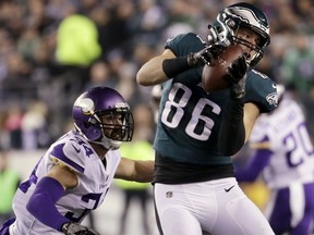 FILE - In this Sunday, Jan. 21, 2018, file photo Philadelphia Eagles' Zach Ertz catches a pass in front of Minnesota Vikings' Andrew Sendejo during the first half of the NFL football NFC championship game in Philadelphia. The Eagles and the New England Patriots are set to meet in Super Bowl 52 on Sunday, Feb. 4, 2018, in Minneapolis.