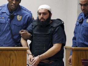 FILE - In this Dec. 20, 2016, file photo, Ahmad Khan Rahimi, center, is led into court in Elizabeth, N.J. Rahimi, who set off small bombs on a New York City street and at a charity race in New Jersey, is set to be sentenced to a mandatory term of life in prison. He is scheduled to be sentenced Tuesday, Feb. 13, 2018, by a federal judge in Manhattan.