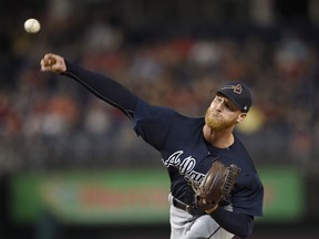 FILE - In this Sept. 14, 2017, file photo, Atlanta Braves starting pitcher Mike Foltynewicz delivers a pitch during the first inning of a baseball game against the Washington Nationals in Washington. Foltynewicz went to salary arbitration with the Atlanta Braves over a different of $100,000, the smallest gap among figures swapped by 27 players with their clubs in Jan. 2018.