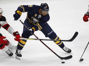 FILE - In this Jan. 30, 2018, file photo, Buffalo Sabres forward Evander Kane (9) controls the puck during the third period of an NHL hockey game against the New Jersey Devils in Buffalo, N.Y. The San Jose Sharks have acquired Kane from the Sabres in a move to upgrade their depleted forward group.