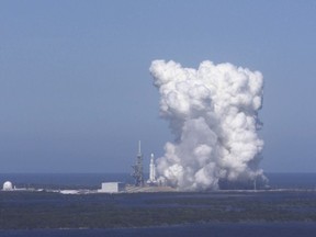 FILE - In this Wednesday, Jan. 24, 2018 image from video made available by SpaceX, a Falcon Heavy rocket is test fired at Cape Canaveral, Fla. NASA officials said the Falcon Heavy is just the latest evidence of the Kennedy Space Center's transformation into a multi-user spaceport, a total turnaround after decades of space shuttles taking center stage. (SpaceX via AP)