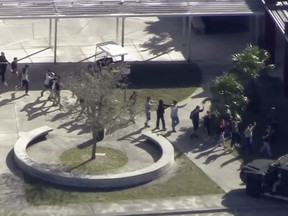 In this frame grab from video provided by WPLG-TV, students from the Marjory Stoneman Douglas High School in Parkland, Fla., evacuate the school following a shooting there on Wednesday, Feb. 14, 2018.