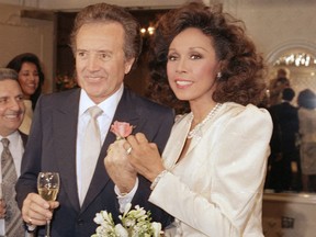 FILE - In this Jan. 3, 1987 file photo, Vic Damone, left, and Diahann Carroll show off their rings after wedding in Atlantic City, N,J. Damone died Sunday, Feb. 11, 2018, at a Miami Beach hospital from complications of a respiratory illness. He was 89.