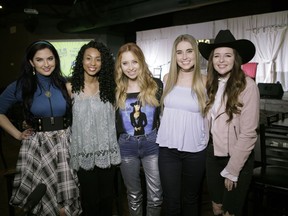 In this Jan. 29, 2018 photo provided by Song Suffragettes, Inc., members of the Song Suffragettes, from left, Candi Carpenter, Tiera Leftwich, Kalie Shorr, Chloe Gilligan and Jenna Paulette pose for a photo in Nashville, Tenn. Female musicians in Nashville have long complained about the lack of representation on country radio, but now a collective of female songwriters are singing "Time's Up." Nearly two dozen women, all belonging to the Song Suffragettes collective, sang on the "Time's Up" song and music video released earlier this month.