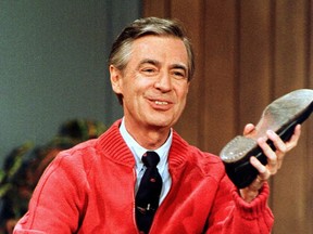 FILE - This June 28, 1989, file photo, shows Fred Rogers as he rehearses the opening of his PBS show "Mister Rogers' Neighborhood" during a taping in Pittsburgh. It's been 50 years since Fred Rogers first appeared on our TVs, a gentle and avuncular man who warbled "Won't You Be My Neighbor?" The golden anniversary of America's favorite neighbor's appearance is being celebrated with a PBS special next month, a new stamp, a feature-length documentary coming out this summer and plans for a Tom Hanks-led biopic.