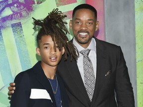 FILE - In this Aug. 1, 2016 file photo, Jaden Smith, left, and his father Will Smith attend the world premiere of "Suicide Squad" in New York. The Smiths have founded an eco-friendly bottled-water company called Just, which is unveiling a new line of flavored waters next month.