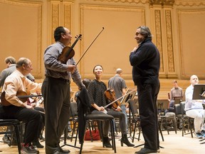 This Feb. 9, 2018 photo released by the Chicago Symphony Orchestra shows Riccardo Muti, standing right, during a rehearsal for the Chicago Symphony Orchestra 2018 Winter Tour at Carnegie Hall in New York.
