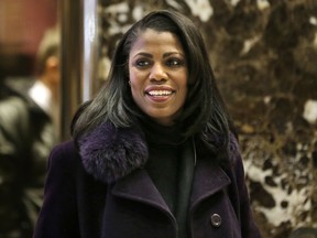 FILE - In this Dec. 13, 2016 file photo, Omarosa Manigault smiles at reporters as she walks through the lobby of Trump Tower in New York. Manigault Newman is a cast member on "Celebrity Big Brother," premiering Thursday on CBS.