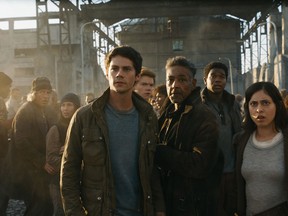 FILE - This undated image released by Twentieth Century Fox shows, foreground from left, Dylan O'Brien, Giancarlo Esposito and Rosa Salazar in a scene from "Maze Runner: The Death Cure."  Last week's no. 1 film, "Maze Runner: The Death Cure" slid 58 percent in its second week with $10.2 million in ticket sales.(Twentieth Century Fox via AP, File)