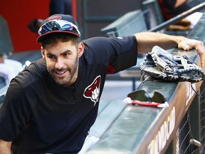 FILE - In this Oct. 2, 2017, file photo, Arizona Diamondbacks right fielder J.D. Martinez smiles as he talks with another player during practice at Chase Field for a National League wild-card playoff baseball game in Phoenix. A person familiar with the negotiations says slugger Martinez and the Boston Red Sox have agreed to a $110 million, five-year contract. The person spoke to The Associated Press on condition of anonymity Monday, Feb. 19, 2018, because the agreement was subject to a successful physical and had not been announced.