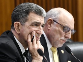 FILE - In a Monday, Feb. 5, 2018 file photo, Assemblyman William Magnarelli, D-Syracuse, left, and Assemblyman Michael Benedetto, D-Bronx, listen to testimony from Rochester Mayor Lovely Warren during a joint legislative budget hearing on local government, in Albany, N.Y. Some legislative hearings on the governor's spending proposals go on for up to 13 hours, giving the Empire State some of the nation's most drawn-out budget discussions.