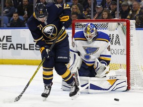 Buffalo Sabres forward Evan Rodrigues (71) tips the puck in front of St. Louis Blues goalie Carter Hitton (40) during the first period of an NHL hockey game, Saturday, Feb. 3, 2018, in Buffalo, N.Y.