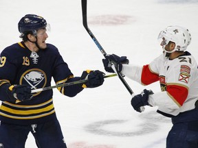 Buffalo Sabres Jake McCabe (19) and Florida Panthers Vincent Trocheck (21) exchange words during the third period of an NHL hockey game, Thursday, Feb. 1, 2018, in Buffalo, N.Y.