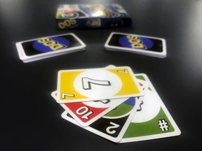 Mattel's new card game Dos is displayed on Monday, Feb. 12, 2018, in New York. Mattel is launching the new card game next month in hopes of giving its nearly 50-year-old Uno brand a second life. Dos has similar rules as Uno, except players make two piles of cards and can throw down two cards at a time instead of one.