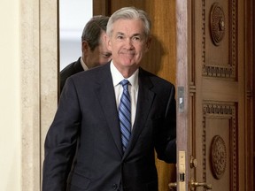 FILE- In this Monday, Feb. 5, 2018, file photo, Jerome Powell arrives to take the oath of office as Federal Reserve Board chair at the Federal Reserve in Washington. On Monday the Dow Jones industrial average endured its worst percentage drop since 2011. The market turbulence had been set off by fears that higher inflation would lead the Fed to accelerate its interest rates hikes and weaken the economy and the stock market. The worry among investors is just one of the issues Powell faces as he succeeds Janet Yellen.