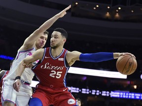 FILE- In this Feb. 14, 2018, file photo, Philadelphia 76ers' Ben Simmons (25) drives to the basket around Miami Heat's Goran Dragic (7) in the second half of an NBA basketball game in Philadelphia. Simmons and Utah Jazz's Donovan Mitchell, the leading rookie of the year candidates, will play together Friday, Feb. 16, 2018, when the NBA's best first- and second-year players compete in the Rising Stars in Los Angeles to tip off All-Star weekend.