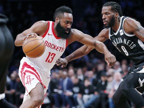 Houston Rockets guard James Harden (13) drives toward the basket as Brooklyn Nets forward DeMarre Carroll (9) defends during the first half of an NBA basketball game, Tuesday, Feb. 6, 2018, in New York.