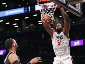 Los Angeles Clippers center DeAndre Jordan (6) dunks in front of two Nets defenders during the first half of an NBA basketball game, Monday, Feb. 12, 2018, in New York.