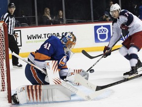 New York Islanders goaltender Jaroslav Halak (41) blocks a shot by Columbus Blue Jackets right wing Josh Anderson (77) during the first period of an NHL hockey game, Saturday, Feb. 3, 2018 in New York.